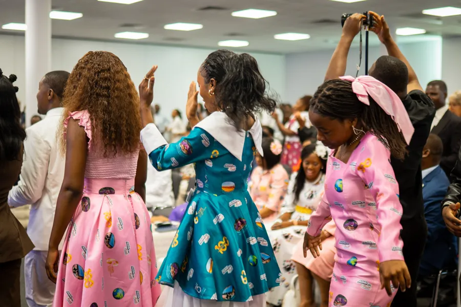 Women in colourful Church Java outfits dancing at a gathering