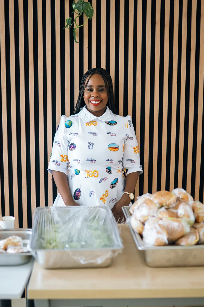 Woman in a printed Church Java shirt serving food