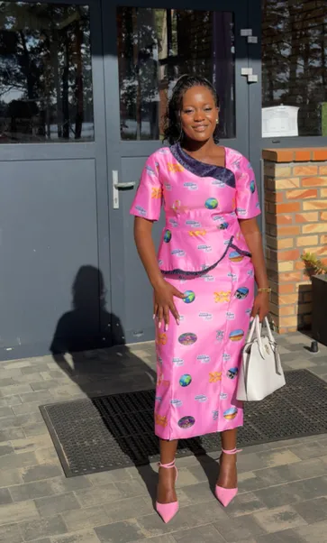 Woman in a pink printed Church Java skirt set with matching heels