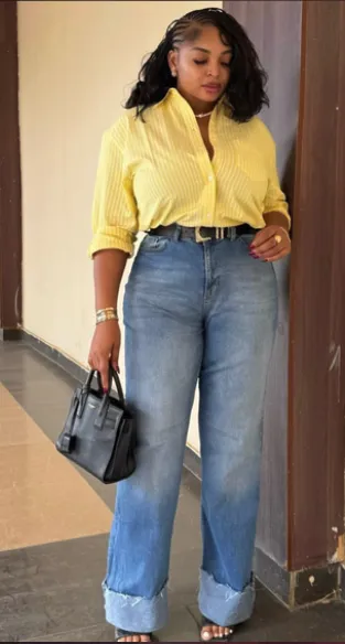 Woman in a pink striped shirt with wide-leg jeans